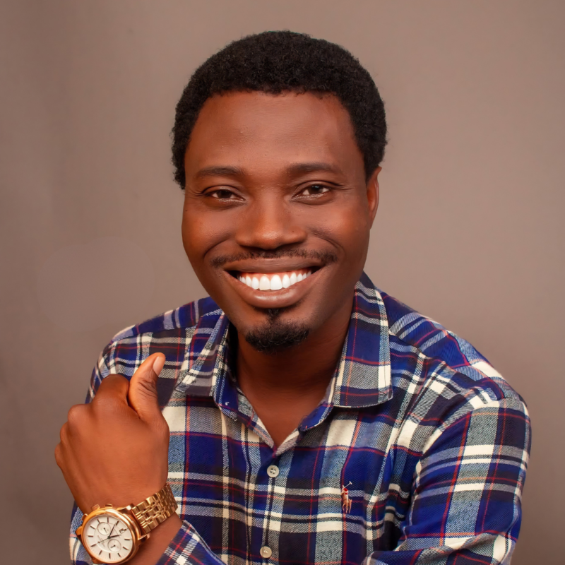Man wearing a golden wrist watch smiling having a checked shirt on