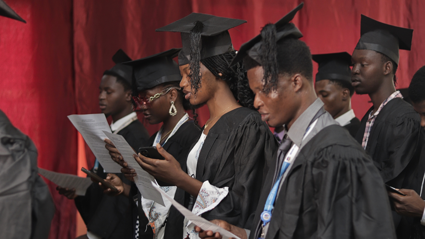 Students in a row wearing a blue matric gown with same colour of hats on the occasion of Mount Zion Institute Matriculation